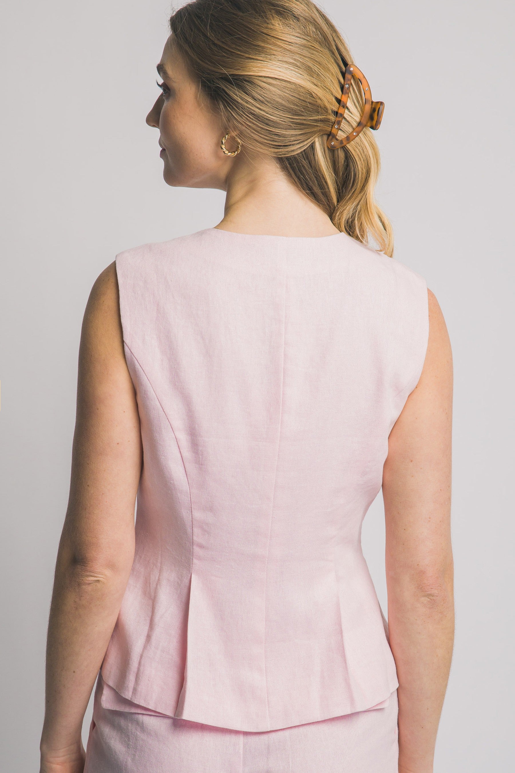 Chaleco sin mangas con botones metálicos y pinzas estilizadas