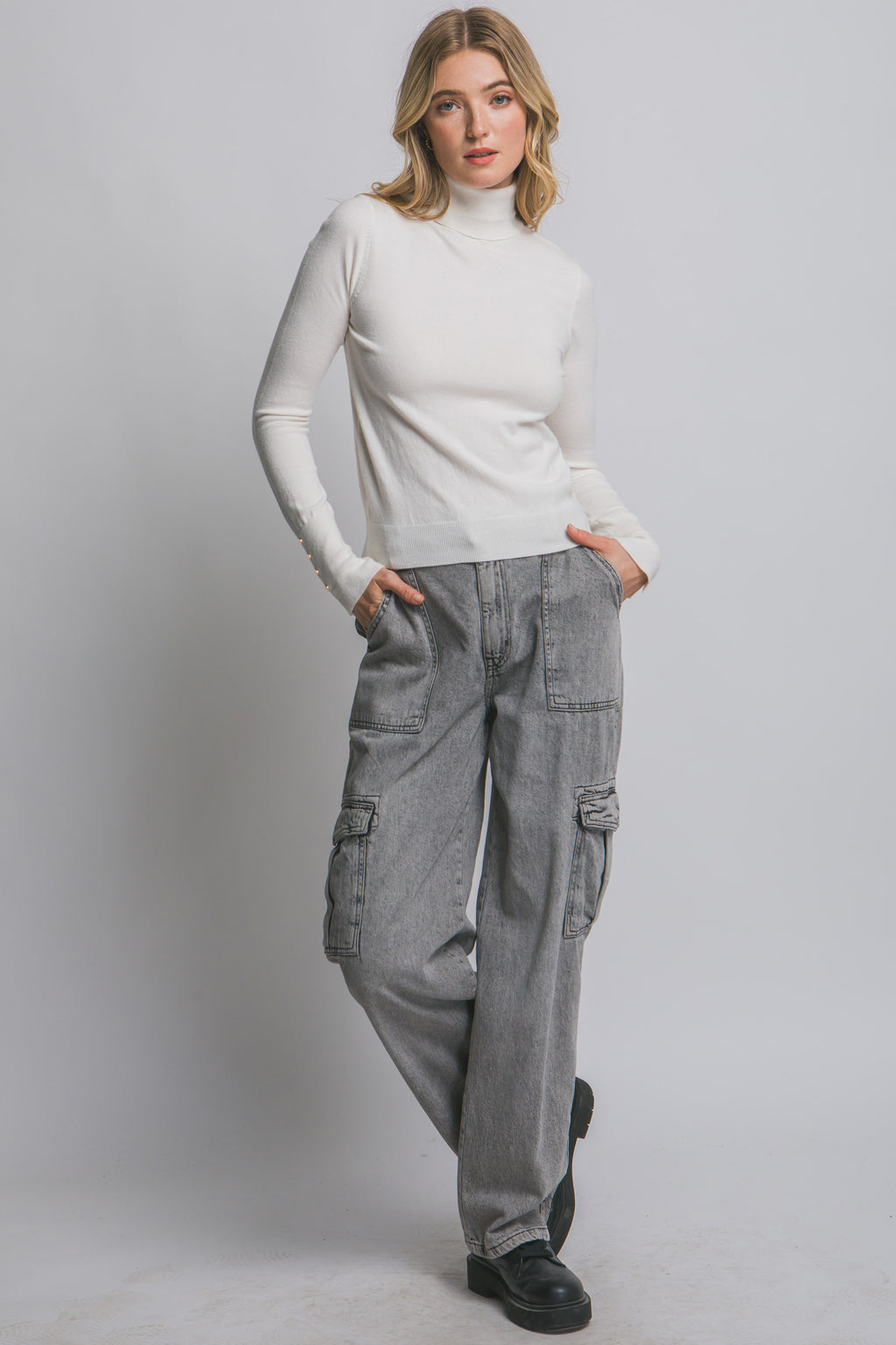 Blusa de punto con cuello alto y botones metálicos