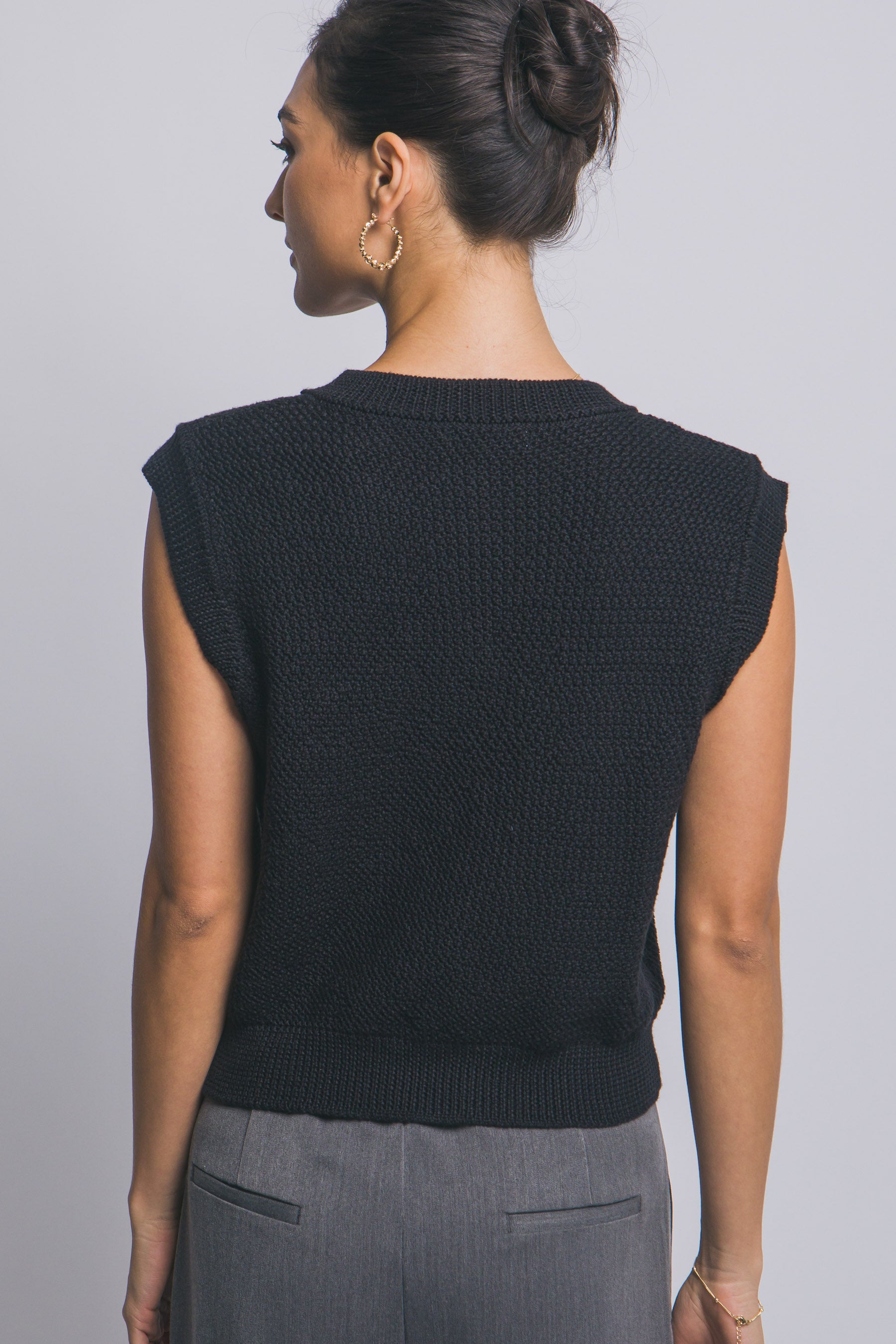 Suéter tejido sin mangas con botones decorativos dorados